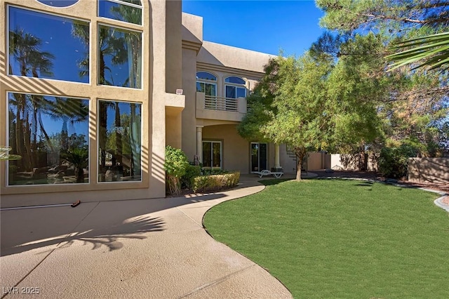 1008 Trophy Hills Dr, Las Vegas, NV 89134 - property entrance with stucco siding, a lawn, and a balcony