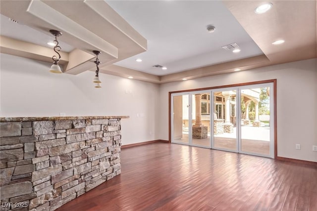 1008 Trophy Hills Dr, Las Vegas, NV 89134 - unfurnished living room featuring wood finished floors, visible vents, baseboards, and a raised ceiling