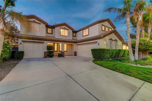 view of front of house featuring concrete driveway, an attached garage, and stucco siding