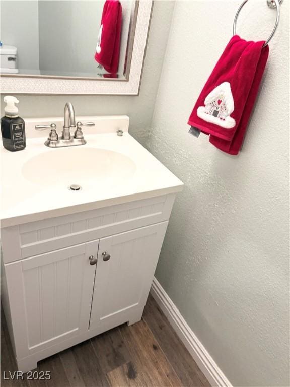 5024 Starfinder Ave, Las Vegas, NV 89108 - bathroom with wood finished floors, vanity, and baseboards