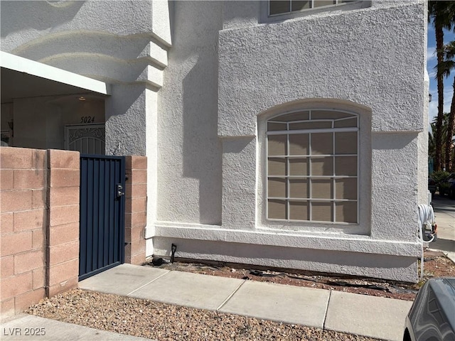 5024 Starfinder Ave, Las Vegas, NV 89108 - exterior view of stucco siding and a gate