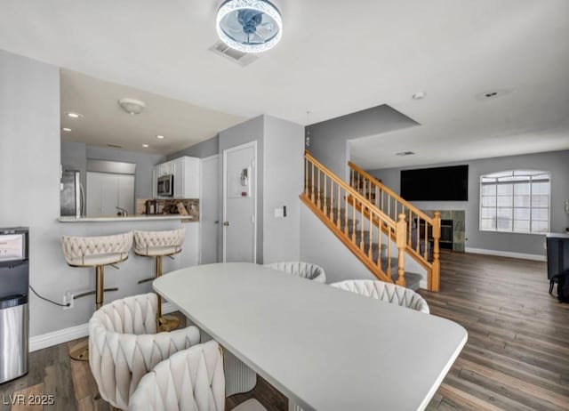 5024 Starfinder Ave, Las Vegas, NV 89108 - dining area with stairs, baseboards, wood finished floors, and recessed lighting