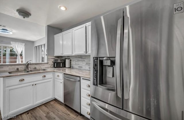 5024 Starfinder Ave, Las Vegas, NV 89108 - kitchen featuring appliances with stainless steel finishes, a sink, tasteful backsplash, white cabinetry, and recessed lighting