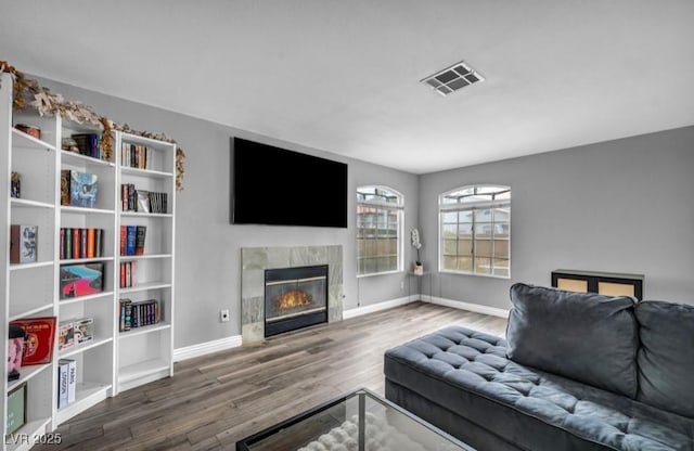 5024 Starfinder Ave, Las Vegas, NV 89108 - living room featuring wood finished floors, a fireplace, and baseboards