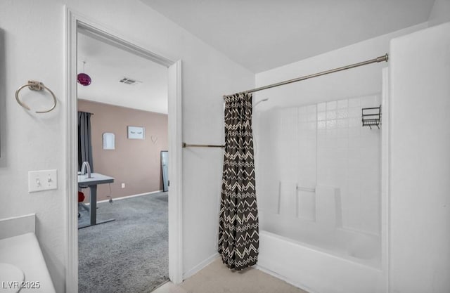 5024 Starfinder Ave, Las Vegas, NV 89108 - bathroom featuring shower / tub combo with curtain and baseboards
