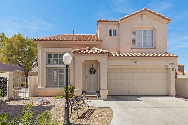 mediterranean / spanish home with driveway, a tiled roof, fence, an attached garage, and stucco siding