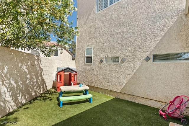 exterior space featuring a playground and fence