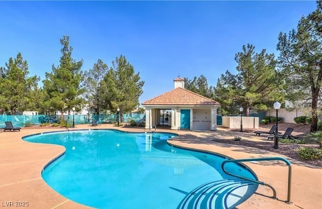 community pool featuring a patio area and fence