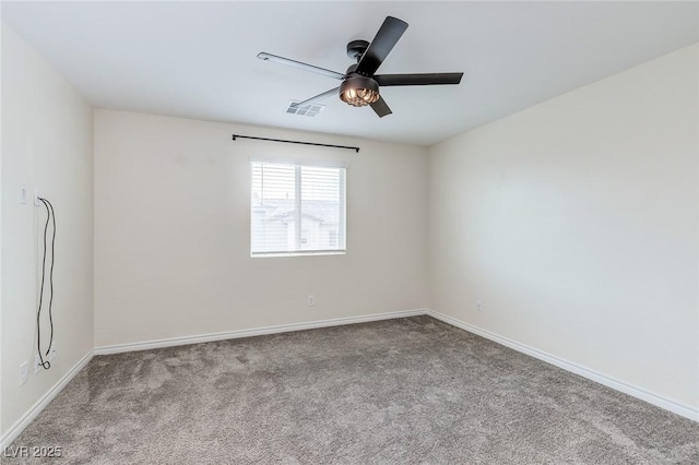 unfurnished room featuring baseboards, carpet flooring, visible vents, and a ceiling fan