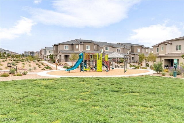 communal playground with a lawn and a residential view
