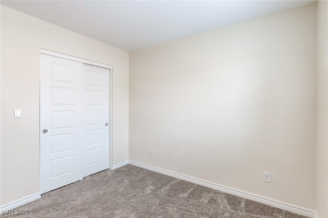 carpeted spare room with baseboards