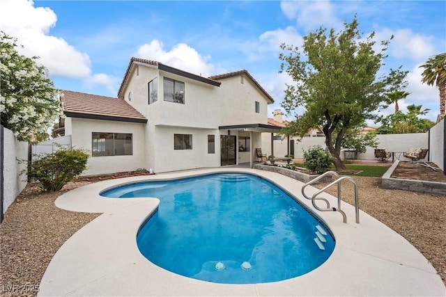 view of swimming pool featuring a patio, a fenced in pool, and a fenced backyard