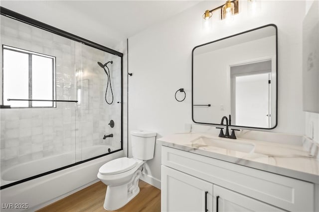 full bathroom with toilet, vanity, combined bath / shower with glass door, and wood finished floors