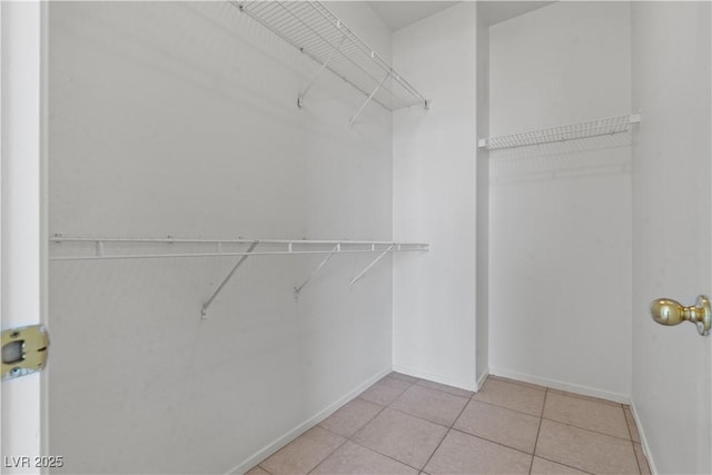 walk in closet with tile patterned floors