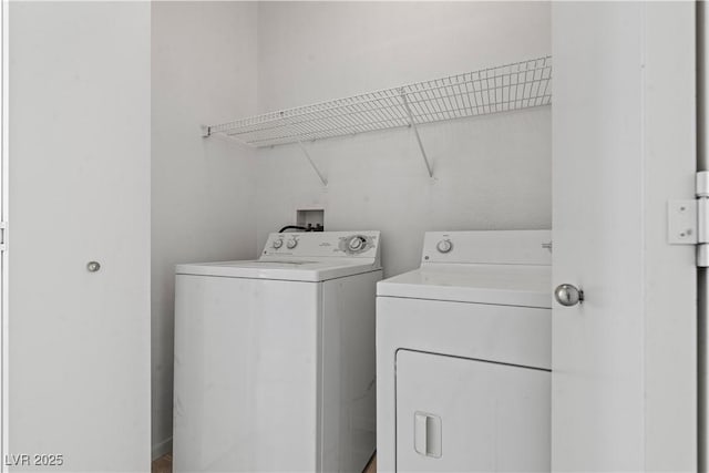 clothes washing area featuring separate washer and dryer