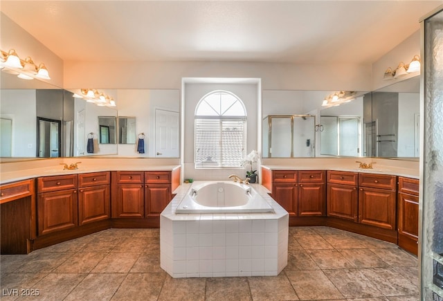 bathroom with a sink, tile patterned floors, a shower stall, two vanities, and a garden tub