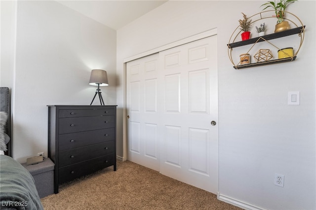 bedroom with baseboards, a closet, and carpet floors