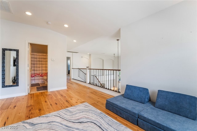 living area with baseboards, recessed lighting, visible vents, and wood finished floors
