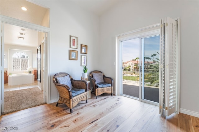 sitting room with light wood finished floors and baseboards