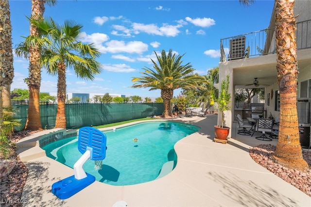 view of swimming pool with ceiling fan, a patio, a fenced in pool, and a fenced backyard