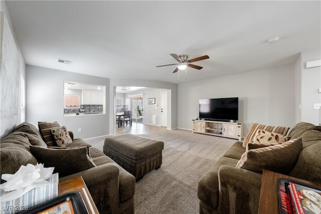 living room with carpet flooring, baseboards, a ceiling fan, and visible vents
