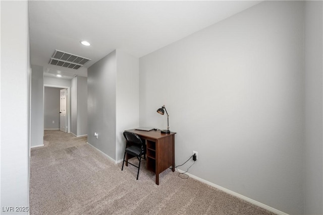 carpeted office space featuring baseboards and visible vents