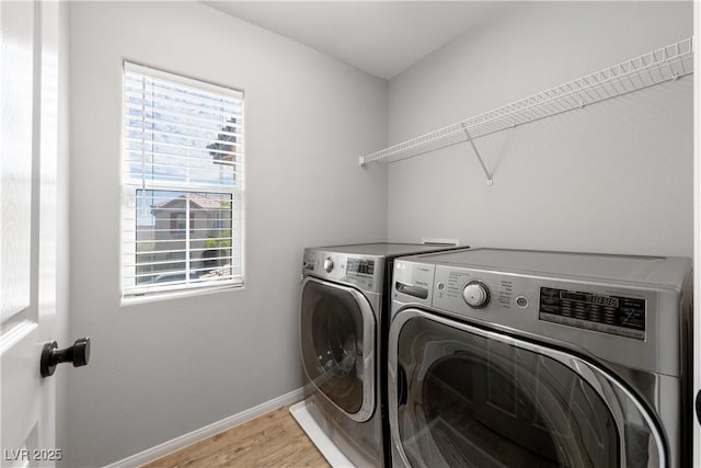 washroom with laundry area, light wood-style flooring, plenty of natural light, and independent washer and dryer
