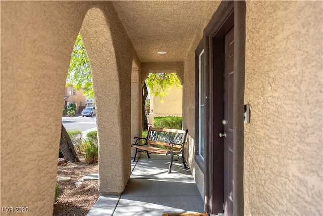 exterior space featuring a porch and stucco siding