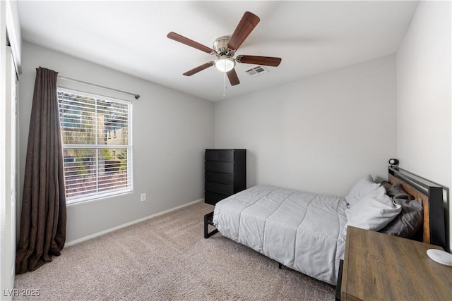 carpeted bedroom with baseboards, visible vents, and ceiling fan