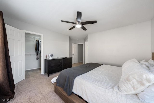 bedroom with a ceiling fan, a closet, carpet, and a walk in closet