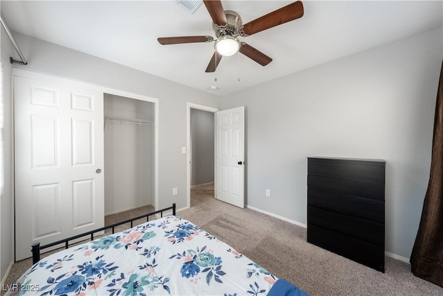 carpeted bedroom with a closet, baseboards, a ceiling fan, and visible vents