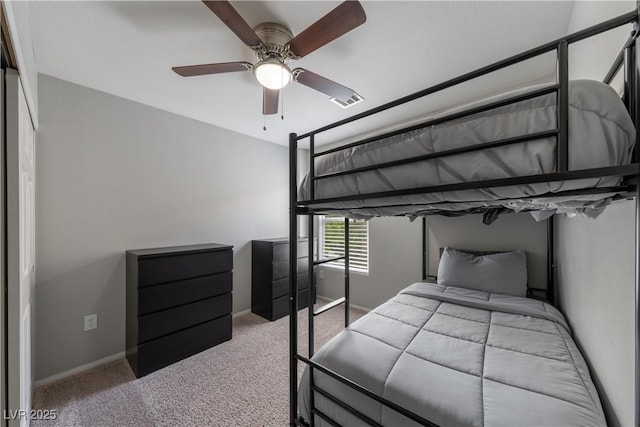 bedroom featuring baseboards, ceiling fan, carpet flooring, and visible vents