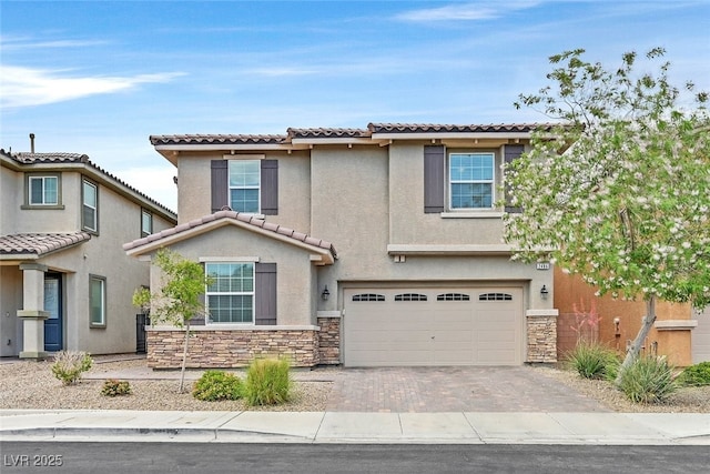 2486 Dragon Fire Ln, Henderson, NV 89052 - traditional home with driveway, a tiled roof, an attached garage, stucco siding, and stone siding