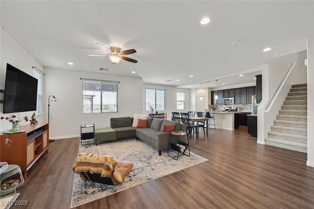 2486 Dragon Fire Ln, Henderson, NV 89052 - living room featuring dark wood finished floors, visible vents, stairway, and recessed lighting