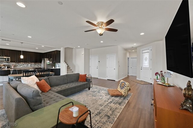 2486 Dragon Fire Ln, Henderson, NV 89052 - living room with a ceiling fan, recessed lighting, baseboards, stairway, and light wood-type flooring