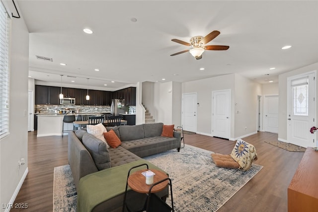 2486 Dragon Fire Ln, Henderson, NV 89052 - living room featuring stairs, ceiling fan, visible vents, and dark wood-style floors