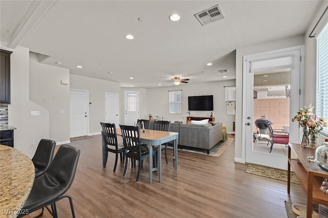 2486 Dragon Fire Ln, Henderson, NV 89052 - dining area featuring recessed lighting, a wealth of natural light, ceiling fan, visible vents, and wood finished floors