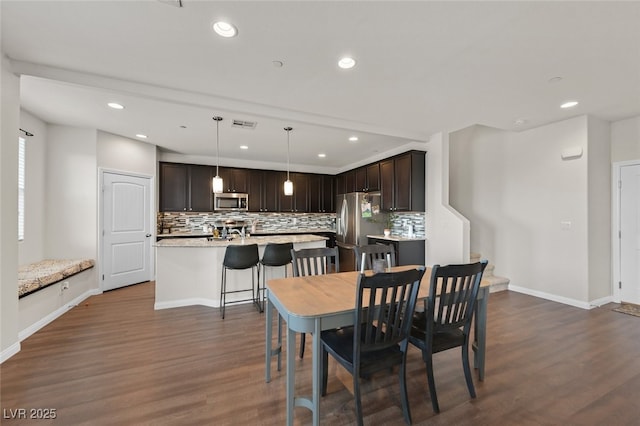 2486 Dragon Fire Ln, Henderson, NV 89052 - dining room featuring baseboards, dark wood-type flooring, visible vents, and recessed lighting