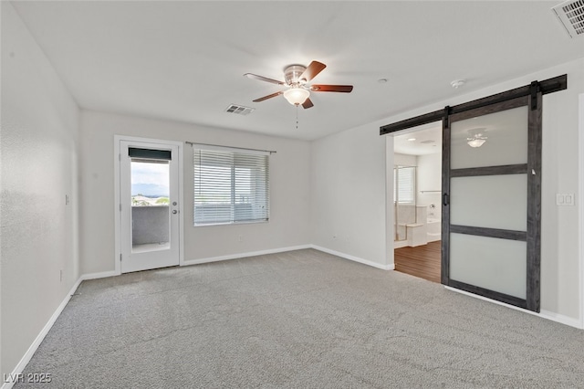 2486 Dragon Fire Ln, Henderson, NV 89052 - unfurnished room featuring ceiling fan, a barn door, visible vents, and carpet