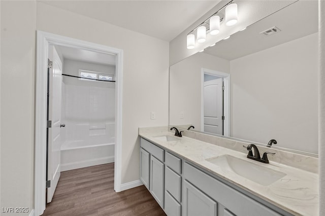 2486 Dragon Fire Ln, Henderson, NV 89052 - bathroom with a sink, double vanity, visible vents, and wood finished floors