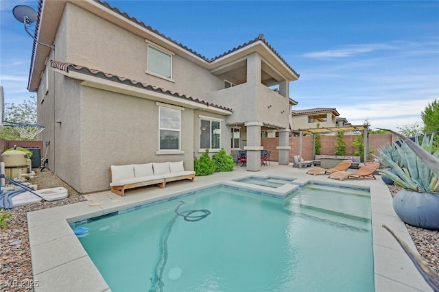 2486 Dragon Fire Ln, Henderson, NV 89052 - rear view of property featuring a patio, an outdoor hangout area, stucco siding, a tile roof, and an in ground hot tub