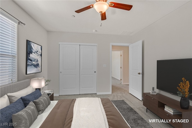 2486 Dragon Fire Ln, Henderson, NV 89052 - bedroom with carpet, a closet, baseboards, and ceiling fan