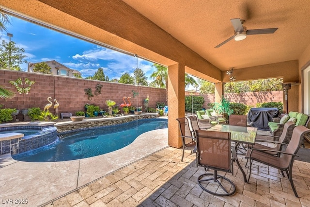 409 Lake Windemere St, Las Vegas, NV 89138 - view of patio / terrace with outdoor dining space, a pool with connected hot tub, ceiling fan, and a fenced backyard