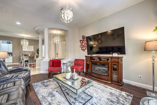 409 Lake Windemere St, Las Vegas, NV 89138 - living area with wood finished floors, decorative columns, a notable chandelier, baseboards, and arched walkways