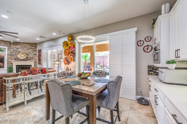 409 Lake Windemere St, Las Vegas, NV 89138 - dining space with a ceiling fan, a fireplace, stone finish floor, visible vents, and recessed lighting