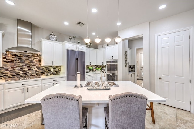 409 Lake Windemere St, Las Vegas, NV 89138 - kitchen with backsplash, wall chimney range hood, stainless steel appliances, and white cabinets