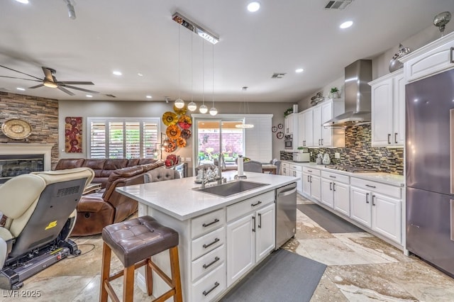409 Lake Windemere St, Las Vegas, NV 89138 - kitchen with ceiling fan, a sink, visible vents, wall chimney range hood, and stainless steel appliances