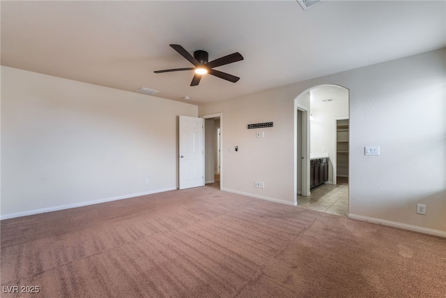 6412 Dimatteo St, Las Vegas, NV 89148 - unfurnished room with arched walkways, a ceiling fan, and light carpet