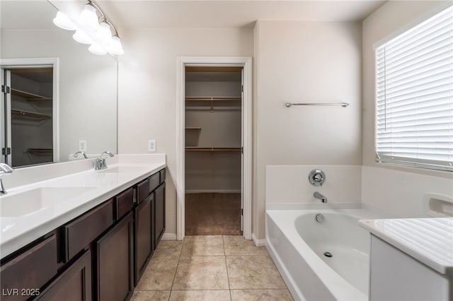 6412 Dimatteo St, Las Vegas, NV 89148 - bathroom with double vanity, a spacious closet, a garden tub, and healthy amount of natural light