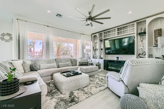 10408 Mezzanino Ct, Las Vegas, NV 89135 - living room with a ceiling fan, visible vents, and wood finished floors